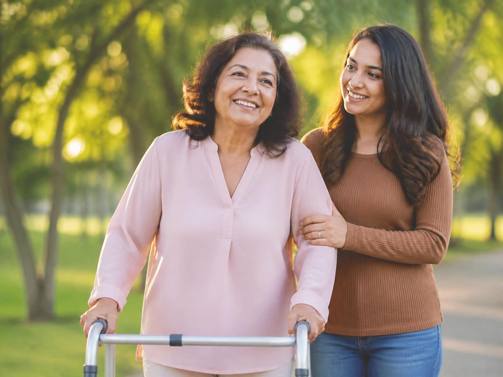 A woman using a walking frame outdoors, smiling beside her daughter